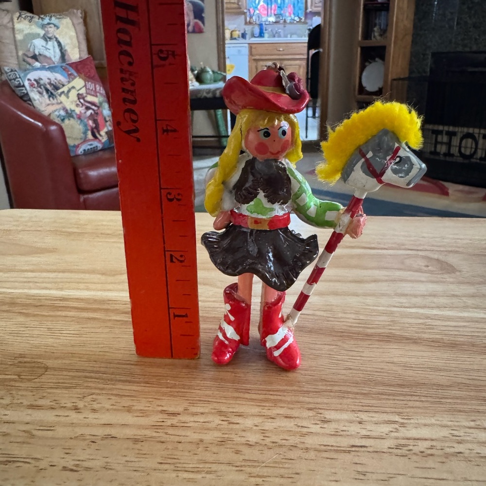 Vintage vibrant colored cowgirl  ornament with stick pony.